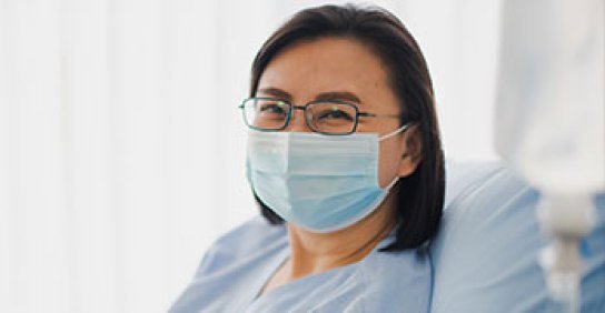 Woman wearing mask and looking at the camera