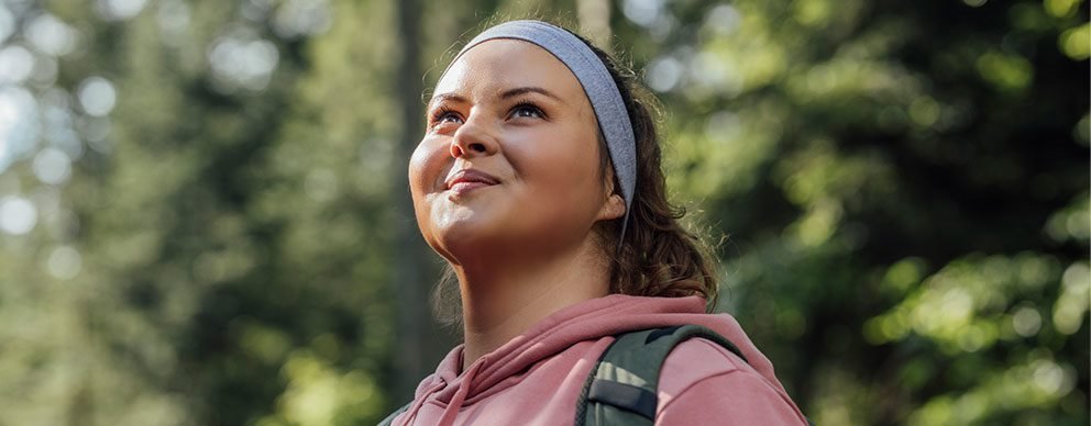 Woman smiling and looking up at the sky